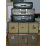 Two early wood bound traveling trunks together with three early suitcases and a pair of folding