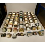 A collection of travel clocks to include, Pepsi cola, Ford, Coral day & date alarm, Roger