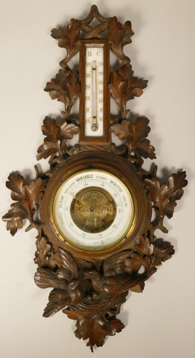 A French carved soft wood barometer and thermometer, with nesting bird decoration, height 61 cm