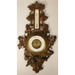 A French carved soft wood barometer and thermometer, with nesting bird decoration, height 61 cm