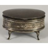 An oval silver trinket box, Chester 1912, raised on four legs, 6.5 x 4.5cm, loaded.