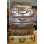 A collection of six early suitcases together with a box of ceramics and glass decanters.