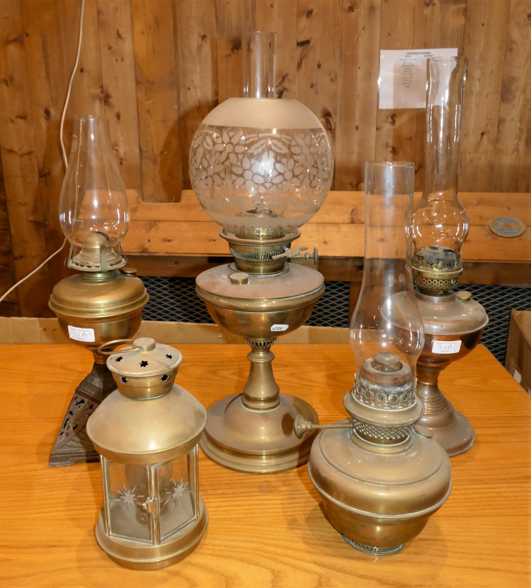 A collection of five brass and copper oil lamps, including chimeras. (5)