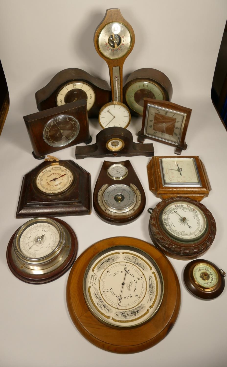 A collection of clocks to include, wooden mantel clocks and barometers