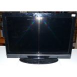 A Techwood 32884 HD 32" 1080p, LCD television, together with power supply and remote