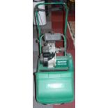 A Qualcast, classic petrol 35s lawnmower, together with a Bosch ARM 32 F electric scarifier (2)