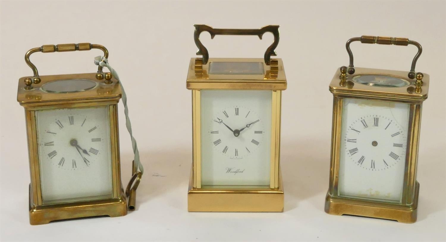 A Woodford, brass manual wind carriage clock 17 cm, together with two unmarked brass carriage clocks