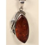 A silver and amber pendant, bracelet with matching ear rings and two pairs of ear rings