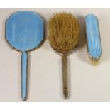 A silver and pale blue enamel three piece dressing table set, Birmingham 1939