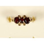 A 9ct gold three stone garnet ring, 2.1gm, M