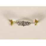 An 18ct gold three stone diamond ring, claw set with brilliants, 1.5gm, J