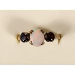 A 9ct gold opal and garnet three stone ring, 2.6gm, Q