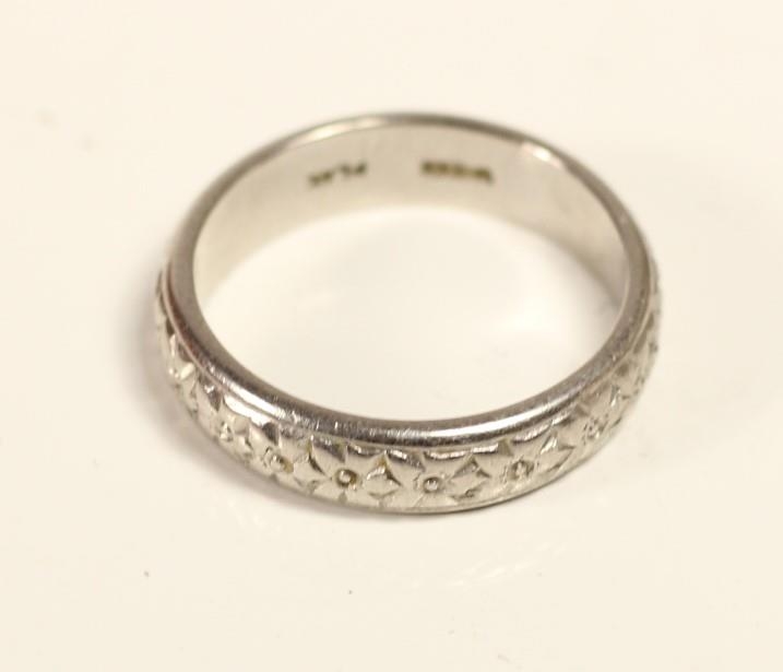 A platinum wedding band with cast floral decoration, stamped PLAT, 8.3 gm, P - Image 2 of 2