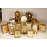 A collection of clocks to include, a Lionel Peck lantern clock, a Junghans Astara quartz clock, a