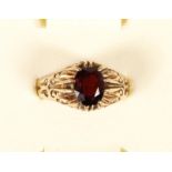 A 9ct rose gold and garnet ring, 4.4gm, G