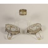 A pair of silver and cut glass butter dishes, Birmingham 1931, with pierced decoration, raised on