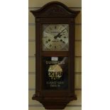 A mahogany cased manual wind wall clock, bearing 'Guinness Dublin'