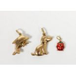 Three 9ct gold charms, a ladybird, dog and dolphins, 2.7gm