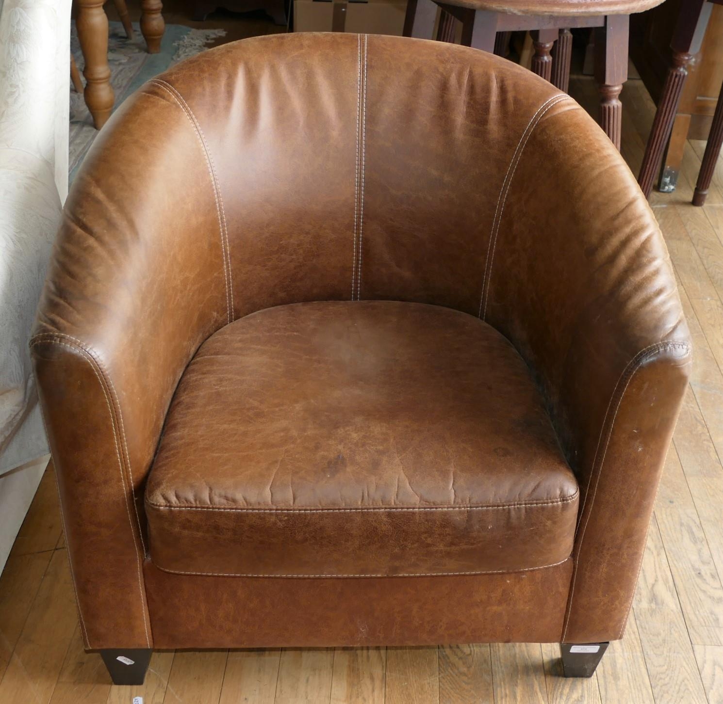 A modern brown leather tub chair. seat height 42cm, 72cm wide.