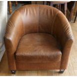 A modern brown leather tub chair. seat height 42cm, 72cm wide.