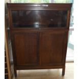 An early 20th century oak workman's cabinet, with hinged doors and Globe Wernicke style glazed top