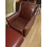 A Multiyork leather lounge chair, together with a Multiyork footstool with storage compartment. (