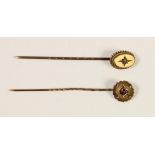 An Edwardian 9ct gold and diamond stickpin, case and a similar garnet set example, 1.4gm