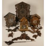 A 19th century Bavarian carved softwood cuckoo clock and three later examples