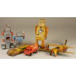 Three wind up tinplate robots together with three other tinplate models.