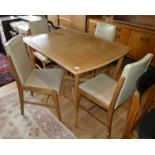 A Mid Century Deco style teak dining suite comprising of a extending dining table with integral leaf