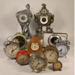 A collection of clocks to include, a barrel shaped quartz clock, a Tam-Tam alarm clock, a gilt metal