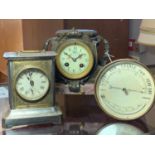 An Aneroid barometer and thermometer, diameter 14 cm, together with a French mantel clock on a