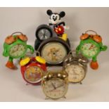 A collection of clocks to include, a boxed Wallace and Gromit alarm clock, Mickey Mouse alarm