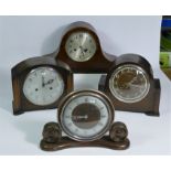 A collection of clocks to include, a Smith Enfield mantel clock, together with other oak cased