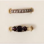 A 9ct gold garnet three stone ring, P and another ring, P, 4.9gm