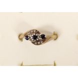 A 9ct gold sapphire and diamond crossover ring, P, 3gm