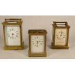 A brass carriage clock, retailed by Swansea Goldsmiths, together with a similar carriage clock,