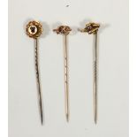 A 15ct gold and sapphire stickpin and two 9ct gold examples