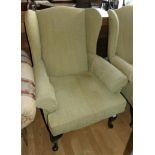 A pair of high backed winged arm chairs in teal green chenille fabric. 98cm tall, 76cm wide.