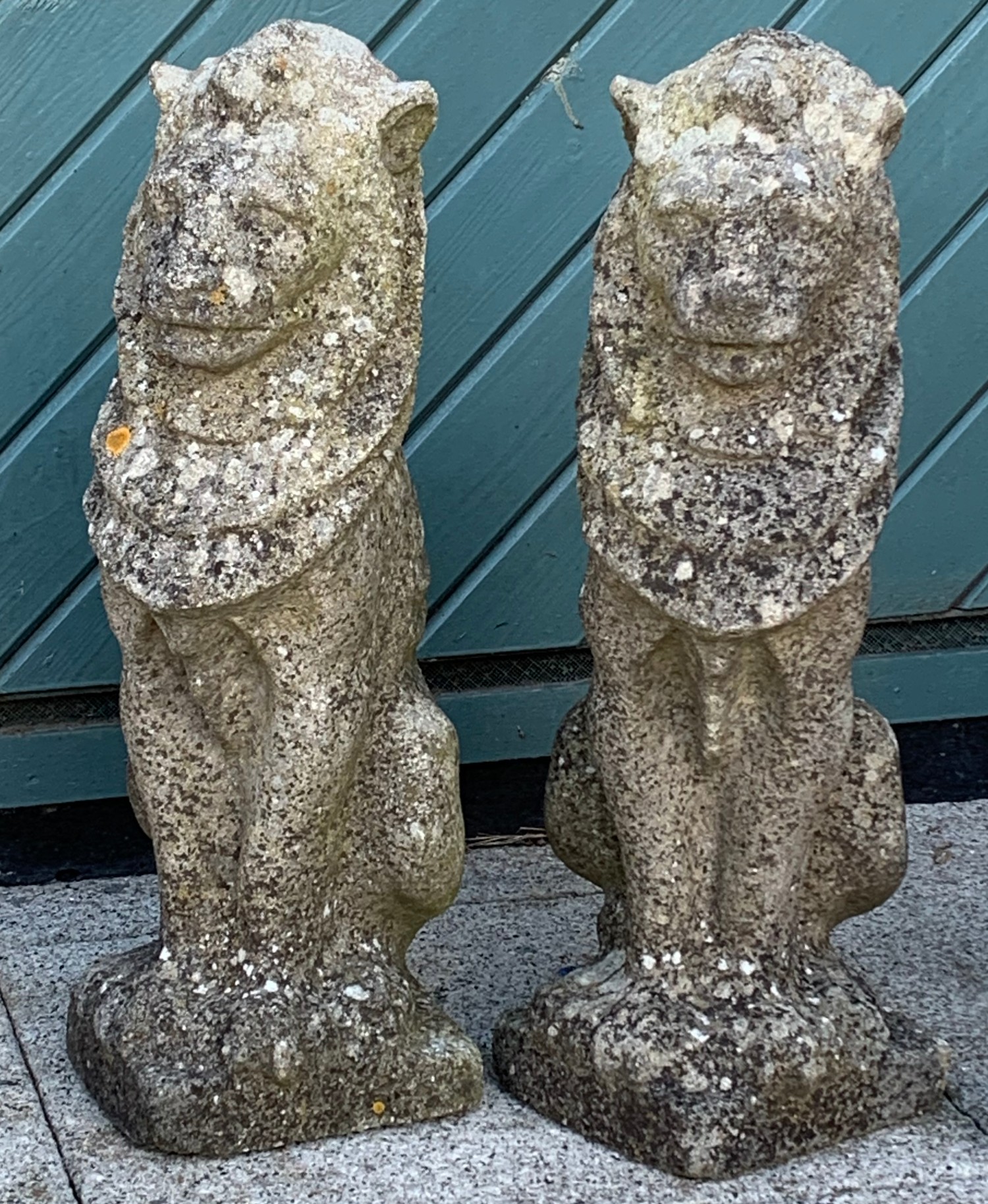 A pair of composite seated lions (2)