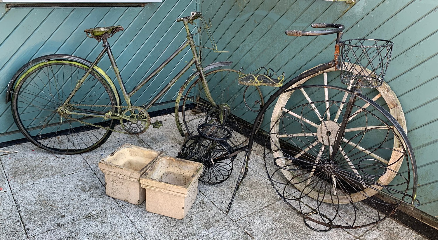 A collection of garden decoration including a early Triumph ladies bicycle, a penny farthing