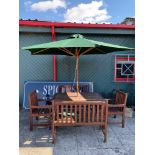 A wooden garden dining set, consisting of a table, two matching wood benches, two matching wooden