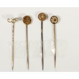 A Victorian 15ct gold and diamond stickpin, two other 15ct gold examples and an unmarked one, 6gm.