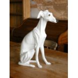 A ceramic fireside model of a seated Whippet dog. 54cm tall.