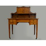 A Victorian mahogany writing desk, with inlaid reticulated gallery panels, inset leather skiver