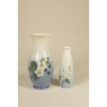 Two porcelain Royal Copenhagen vases, white and blue body with painted flowers with blackberries,