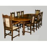 A late 19th century oak wind out dining table with three leaves, together with a set of eight