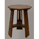 An Art Nouveau Liberty oak side table, with octagonal top on three heart pierced tapered legs.