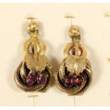 A Victorian pair of gold and garnet floral scroll ear rings, later screw fittings, 30mm, 3.8gm