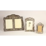 A silver mounted double photograph frame, stamped 925, with embossed decoration, 22 x 27cm and two